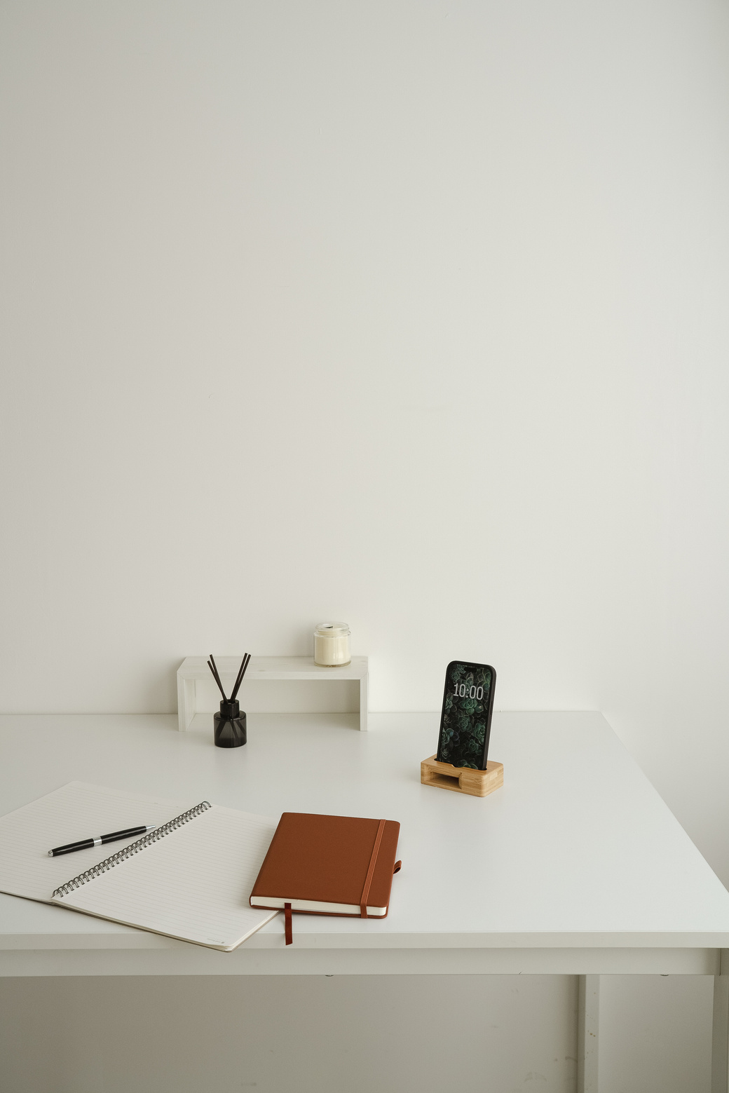 Minimalist Home Office Desk Shot with Notebooks and Decor
